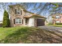 Well-maintained two-story home with a brick and siding exterior, a two-car garage, and a green front lawn at 6514 Trevia Ct, Indianapolis, IN 46236