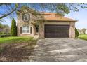 Charming two-story home featuring a brick facade, attached garage, and well-maintained front yard at 6514 Trevia Ct, Indianapolis, IN 46236