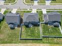 Aerial view of home with a fenced backyard, green lawn, and proximity to neighborhood streets at 7144 Hart St, Cumberland, IN 46229