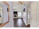View from the entry to the living room showcasing a fireplace and lots of natural light at 7618 Ballyshannon St, Indianapolis, IN 46217