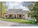 Charming brick home with a balcony and well-maintained lawn on a sunny day at 775 W Hawthorne St, Zionsville, IN 46077