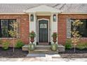 Elegant front entrance with stone steps, decorative plants, and a beautiful door at 775 W Hawthorne St, Zionsville, IN 46077