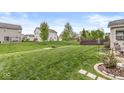 Spacious backyard featuring a lush lawn and mature trees, perfect for outdoor activities at 7829 Hedgehop Dr, Zionsville, IN 46077