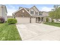 Attractive two-story home with a three-car garage and well-maintained lawn at 7829 Hedgehop Dr, Zionsville, IN 46077