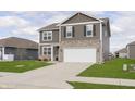 Charming two-story home with gray siding, stone accents, well-manicured lawn, and an attached two-car garage at 813 Sonoma Ln, Greenfield, IN 46140