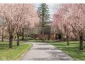 Charming brick home with a winding driveway, accentuated by beautiful weeping cherry trees in full bloom at 8551 E 300 S, Zionsville, IN 46077
