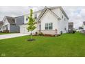 Two-story house with an attached three-car garage and landscaped front yard at 8654 Tripp Rd, Pendleton, IN 46064