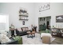 Bright living room featuring modern decor, high ceilings, and stylish furnishings at 10538 Rose Mill Dr, Lawrence, IN 46235