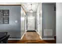 Bright foyer with tile flooring, leading to an open living space, adorned with decorative wall art at 106 W Delaware St, Fortville, IN 46040