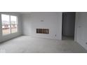 Bright living room featuring a large window and a fireplace, ready for finishing touches and personalization at 12417 Fresh Stock Dr, Noblesville, IN 46060