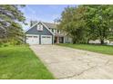 Inviting two-story house featuring a spacious driveway and a two-car garage at 12449 Huntington Dr, Indianapolis, IN 46229