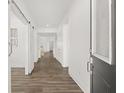 Bright hallway with wood flooring, white walls, modern sliding barn door, and neutral accents at 1285 Chatham Hills Blvd, Westfield, IN 46074