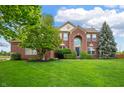 Charming brick home with well-manicured lawn and mature trees creating great curb appeal at 14145 Charity Chase Cir, Carmel, IN 46074