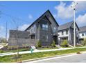 Contemporary home with clean lines, neutral siding, and a professionally landscaped yard at 1702 Alvord St, Indianapolis, IN 46202