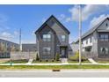 Modern two-story home featuring sleek dark siding and manicured landscaping at 1702 Alvord St, Indianapolis, IN 46202