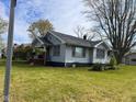 Charming single-story home with a well-maintained lawn and classic architectural details at 1802 Poplar St, Anderson, IN 46012