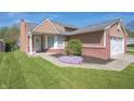Well-maintained home featuring a lush lawn, colorful flower bed, and attached two-car garage at 18771 Northridge Dr, Noblesville, IN 46060