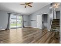 Bright living room featuring sliding glass doors, modern flooring, and staircase access at 18771 Northridge Dr, Noblesville, IN 46060