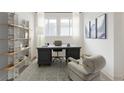 Bright home office with a large desk, stylish chair, and built-in shelving perfect for remote work at 19522 Wood Farm Pl, Westfield, IN 46074