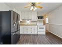 White kitchen with modern appliances, hardwood floors, and white cabinetry at 250 3 Notch Ln, Bargersville, IN 46106