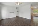 Spacious living room features hardwood floors, fresh paint, and a ceiling fan at 250 3 Notch Ln, Bargersville, IN 46106