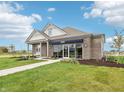 Beautiful model home with lush green lawn, blue skies, and inviting walkway at 30 Benfield Dr, Whiteland, IN 46184