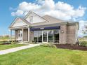Well-maintained model home with manicured landscaping and a welcoming entrance at 30 Benfield Dr, Whiteland, IN 46184