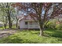Inviting home with a manicured lawn, mature trees, and a charming facade at 303 W 7Th St, Lapel, IN 46051