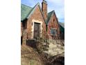 Picture of a cozy red brick home with a green roof and an ornate iron front door at 3208 Brookside Pkwy N Dr, Indianapolis, IN 46218