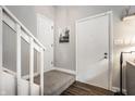Entryway with white doors, carpeted stairs, and hardwood flooring at 354 E Arch St, Indianapolis, IN 46202