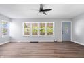 Spacious living room with natural light and wood floors with easy entry door access at 3541 N Linwood Ave, Indianapolis, IN 46218