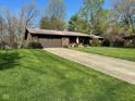 Beautiful single-story brick home on a large lot with a well-manicured lawn at 3920 Pigeon Creek Ln, Indianapolis, IN 46234