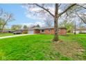 Well-maintained exterior view of the home surrounded by mature trees and green lawn at 4464 Chatham Dr, Brownsburg, IN 46112