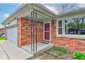 Close-up of the brick facade near the front door with adjacent windows at 4464 Chatham Dr, Brownsburg, IN 46112