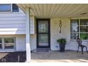 Cozy front porch view featuring a brick facade, porch seating, and a welcoming entrance at 5014 Dawn St, Anderson, IN 46013