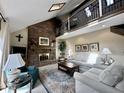 Inviting living room featuring a brick fireplace, high ceilings, and a cozy seating area at 5205 Mosswood Ct, Indianapolis, IN 46254