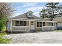 Quaint single-story home with a welcoming front porch and ample parking space at 5209 Melrose Ave, Indianapolis, IN 46241