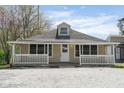 Inviting single-story home with a classic front porch and white picket fence at 5209 Melrose Ave, Indianapolis, IN 46241