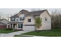 Attractive two-story residence with mixed siding, a two-car garage, and fresh landscaping adding to the curb appeal at 5529 W Turnbuckle Pl, McCordsville, IN 46055