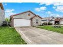 Lovely one-story house featuring a two-car garage, brick detail, driveway, and green lawn at 5666 Ensley Ct, Indianapolis, IN 46254
