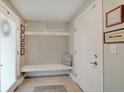 Inviting mudroom area featuring a bench, coat hooks, and neutral decor at 620 Pomeroy St, Indianapolis, IN 46202