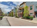 A row of townhomes showcase their unique facades and well-kept landscaping along a brick paved street at 620 Pomeroy St, Indianapolis, IN 46202