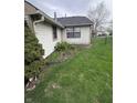 Backyard featuring a well-maintained lawn and minimal garden with a partial fence at 7450 Cobblestone W Dr, Indianapolis, IN 46236