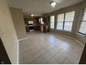 Spacious kitchen featuring tile flooring, ample natural light, wooden cabinetry, and modern appliances at 7450 Cobblestone W Dr, Indianapolis, IN 46236