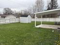 Spacious backyard with a storage shed, carport, and plenty of green grass at 823 N Noble St, Greenfield, IN 46140