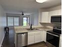Modern kitchen featuring stainless steel appliances, granite countertops, and white cabinetry at 823 N Noble St, Greenfield, IN 46140