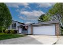 Lovely home boasting a two-car garage, spacious driveway and mature trees at 8232 N Chaucer Ct, Columbus, IN 47201