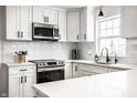 Modern kitchen with stainless steel appliances, white cabinets, quartz countertops, and subway tile backsplash at 8966 Wooster Ct, Fishers, IN 46038