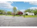 Long driveway leading to a well-maintained home surrounded by mature trees and greenery at 90 S Morgantown Rd, Greenwood, IN 46142
