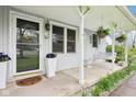 Inviting front porch with swing, decorative plants, and charming curb appeal at 90 S Morgantown Rd, Greenwood, IN 46142